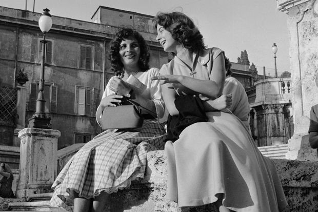 circa 1955: Two young women share a joke during their lunch hour in Rome. (Photo by Evans/Three Lions/Getty Images)